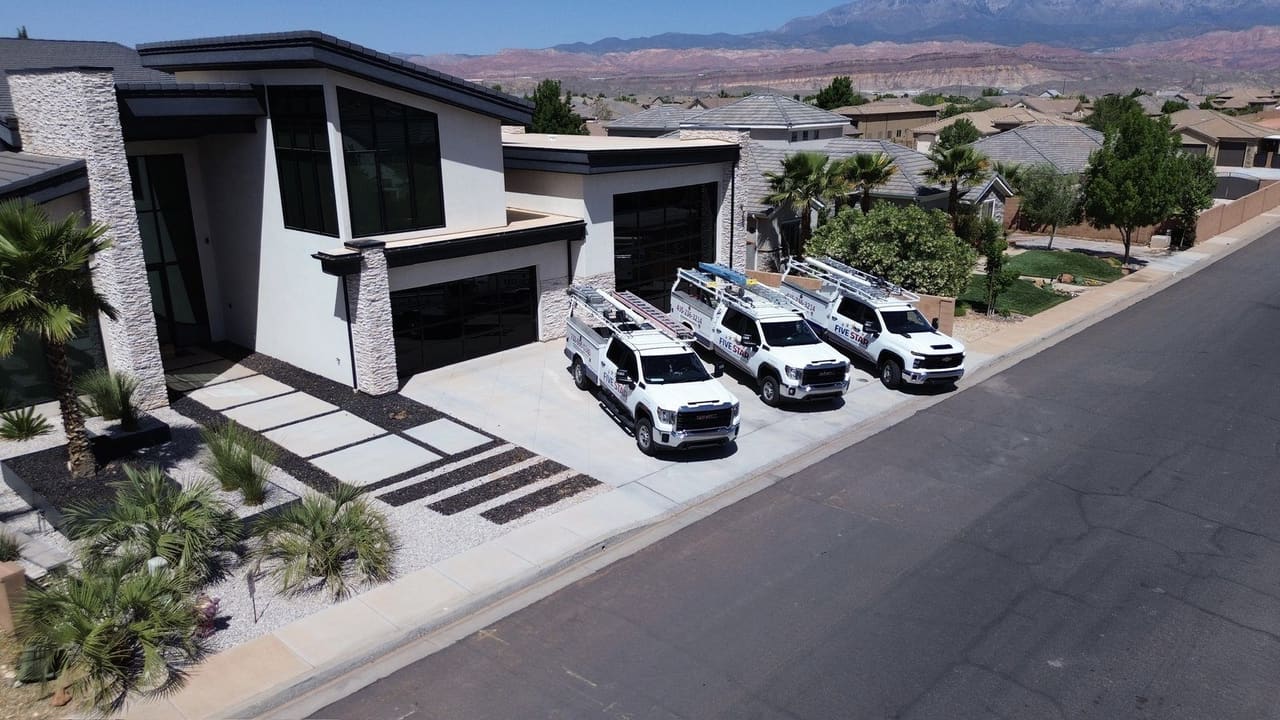 Five Star Air Conditioning, Heating & Plumbing trucks at a St. George job site