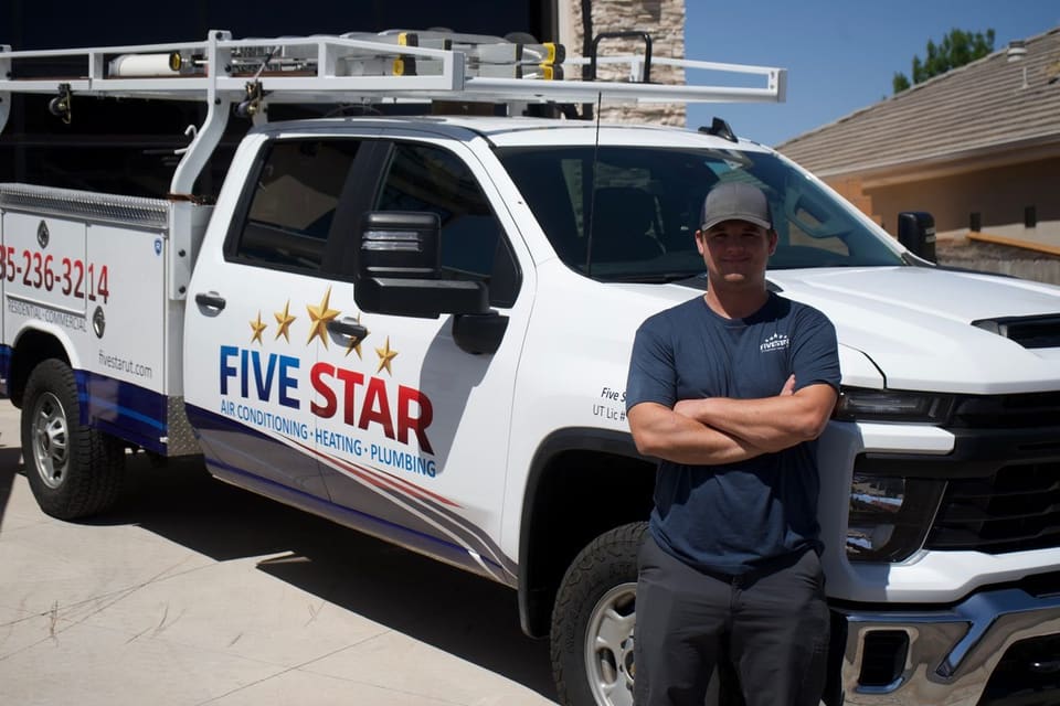 Tanner DeMille standing in front of his Five Star service truck in St. George
