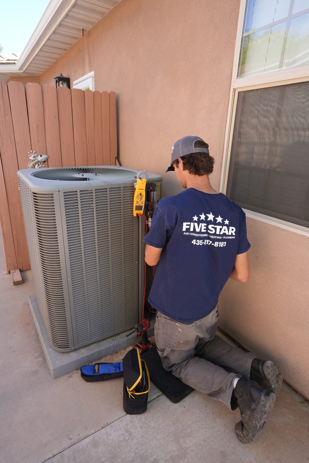 Five Star technician performing an AC repair diagnostic on an air conditioner in St. George, Utah