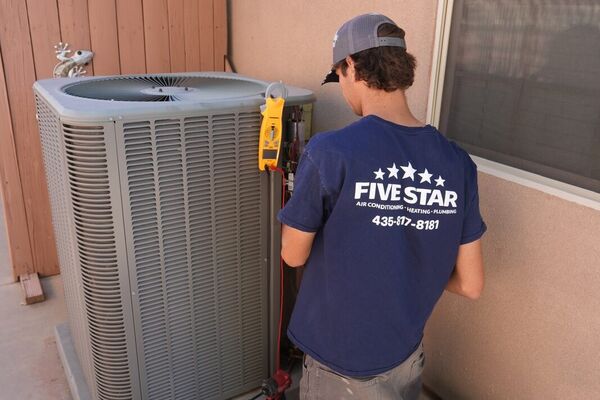 Five Star technician performing an AC repair diagnostic on an air conditioner in St. George, Utah