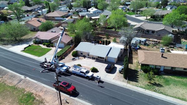 Drone aerial of a Five Star crew swapping a rooftop AC unit with crane