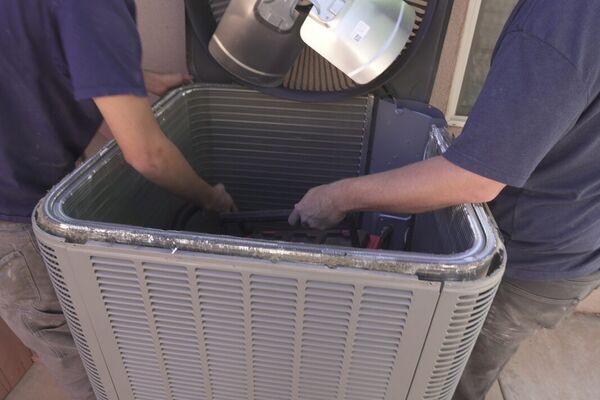 Five Star HVAC technician accessing an attic air handler for service in St. George, Utah