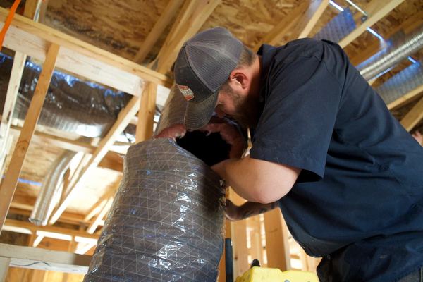 Five Star tech connecting flex duct to a register box in the attic