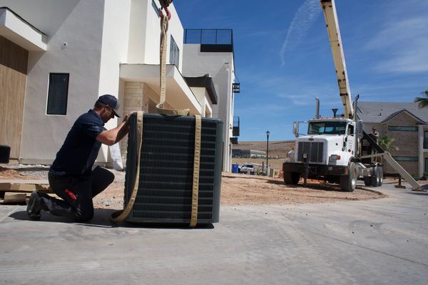 Five Star tech rigging a new condenser before crane lift to rooftop
