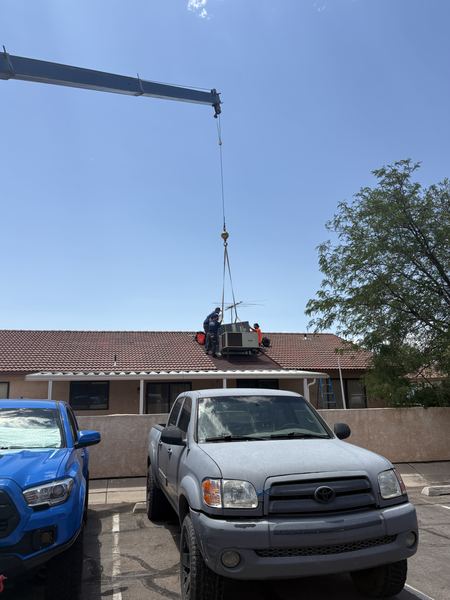 Five Star roof crew preparing to land a new AC unit with crane assist