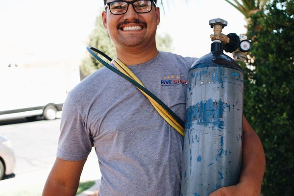 Five Star HVAC technician with a nitrogen tank during an AC service call in St. George, Utah