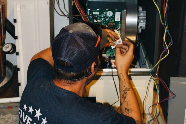 Five Star technician servicing a furnace control board in St. George, Utah