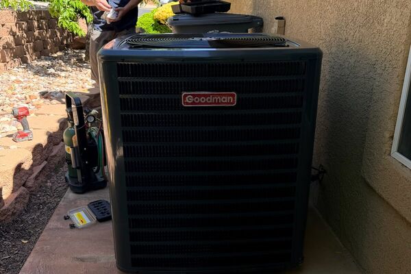 Five Star HVAC technician servicing a Goodman air conditioning condenser in St. George, UT