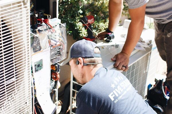 Five Star HVAC techs working on an outdoor air conditioning unit in St. George, Utah